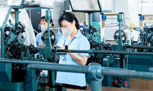 Workers operating on PCTFE manufacture machines