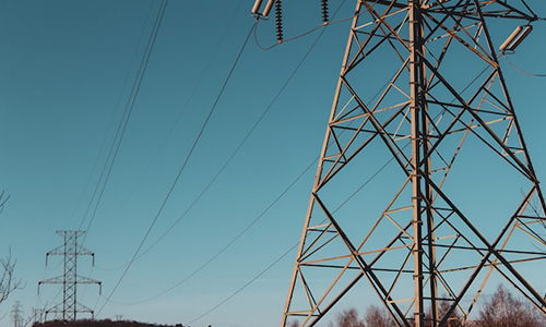 Phone lines and transmission towers in a field